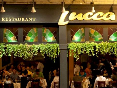 A bustling restaurant named Lucca with diners visible through the windows.