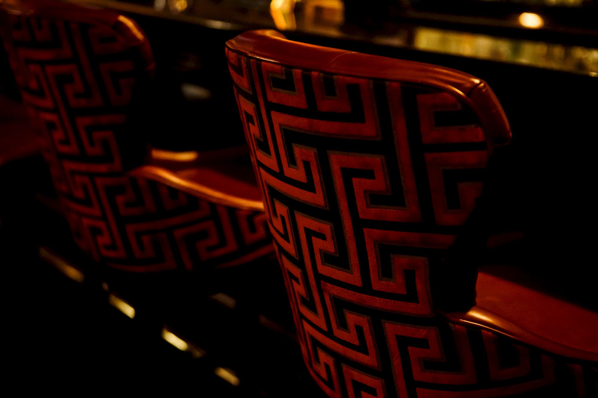 Red chairs with a Greek key pattern.
