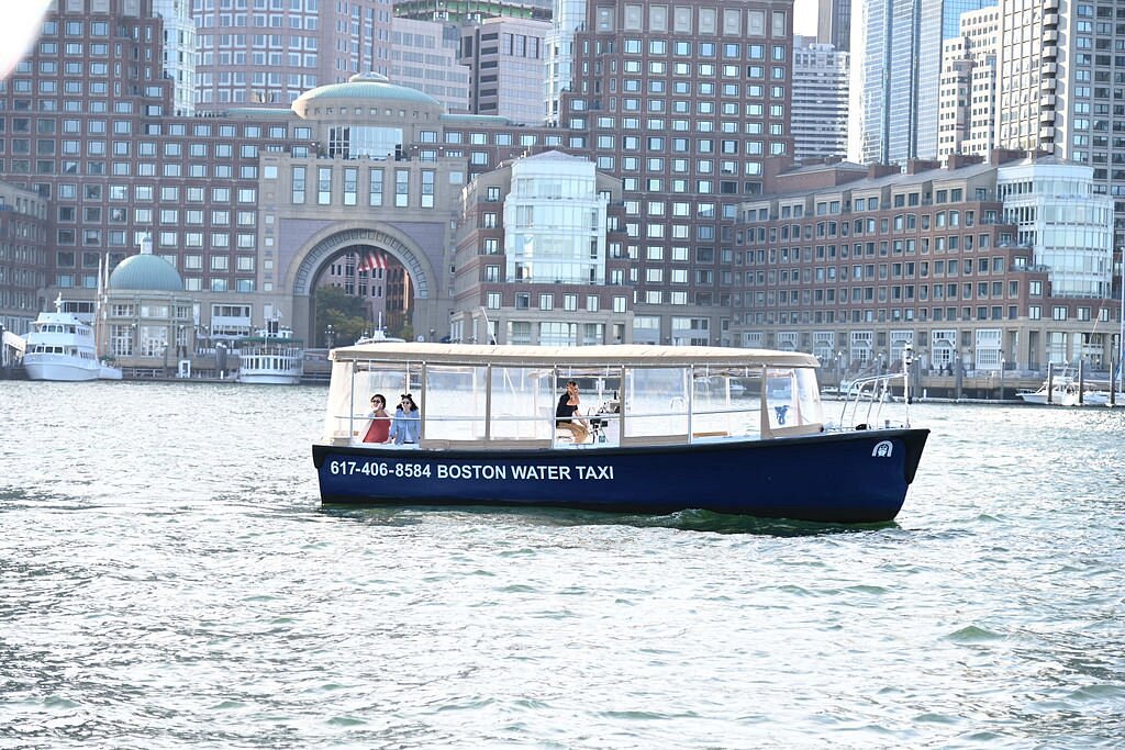 A blue water taxi labeled 