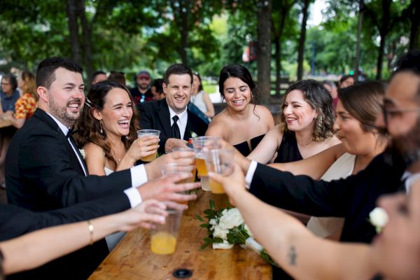 Wedding Party toasting glasses of beer at the beer garden